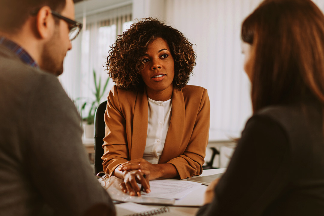 A man and a woman meeting with an advisor