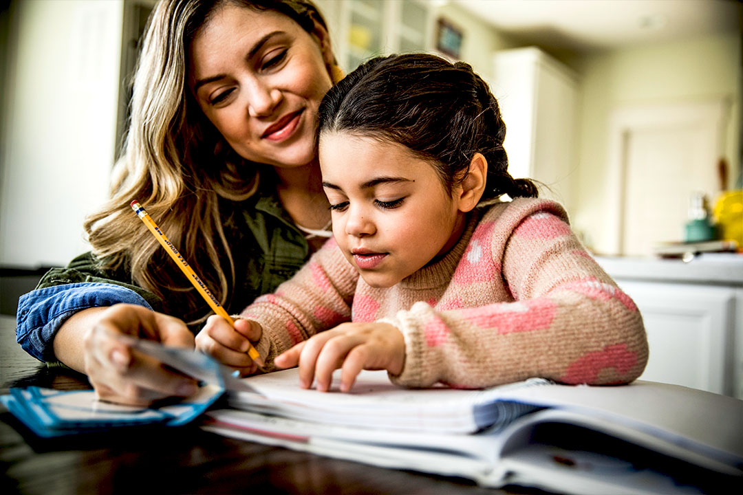 mother helping daughter with homework