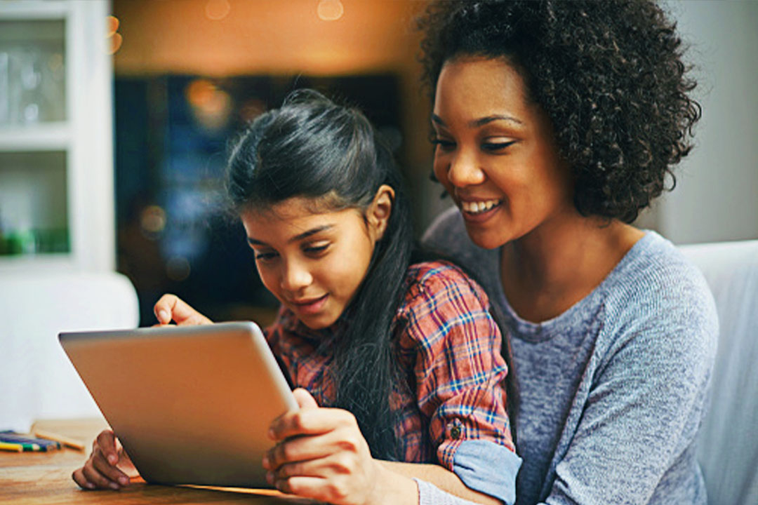 Mother and daughter looking at tablet